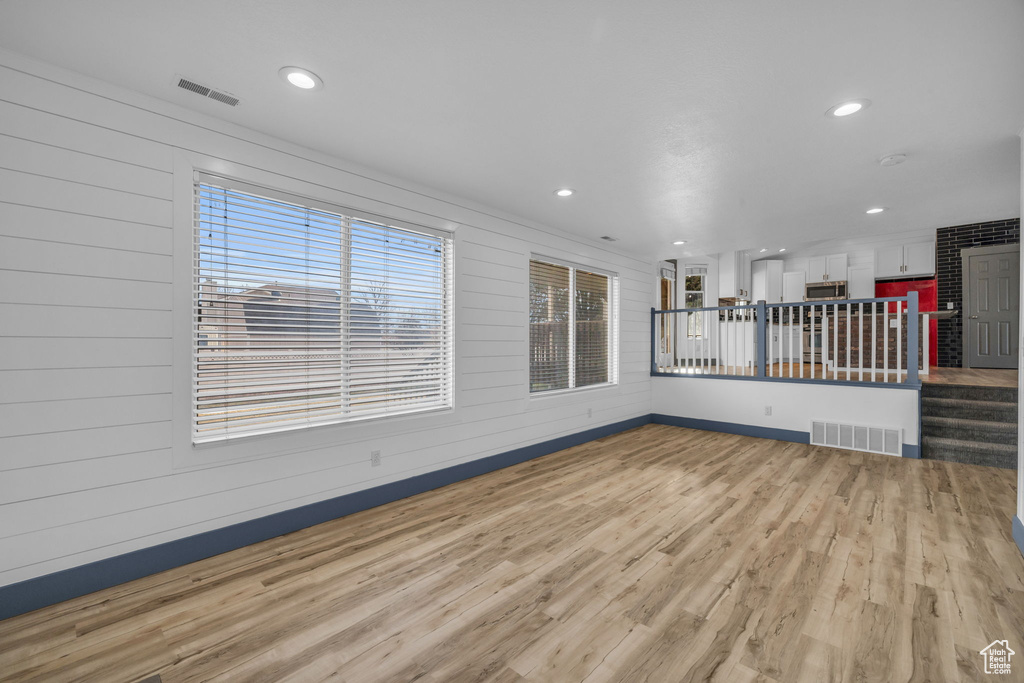 Unfurnished living room with hardwood / wood-style flooring