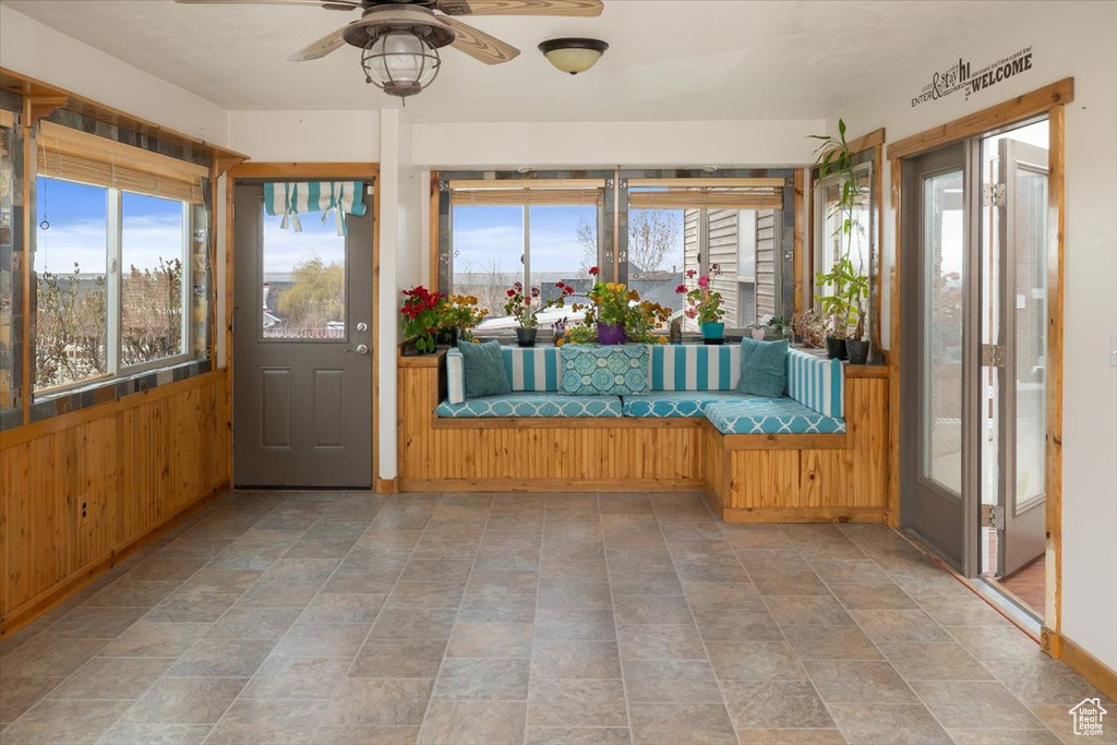 Unfurnished sunroom with ceiling fan