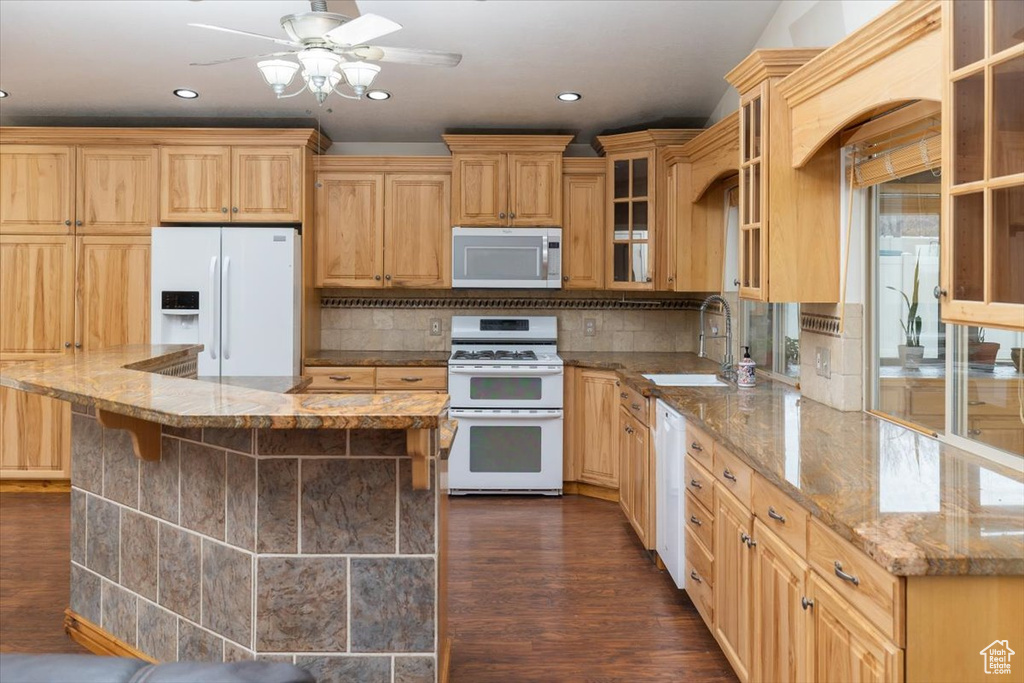 Kitchen with ceiling fan, tasteful backsplash, white appliances, dark hardwood / wood-style floors, and sink