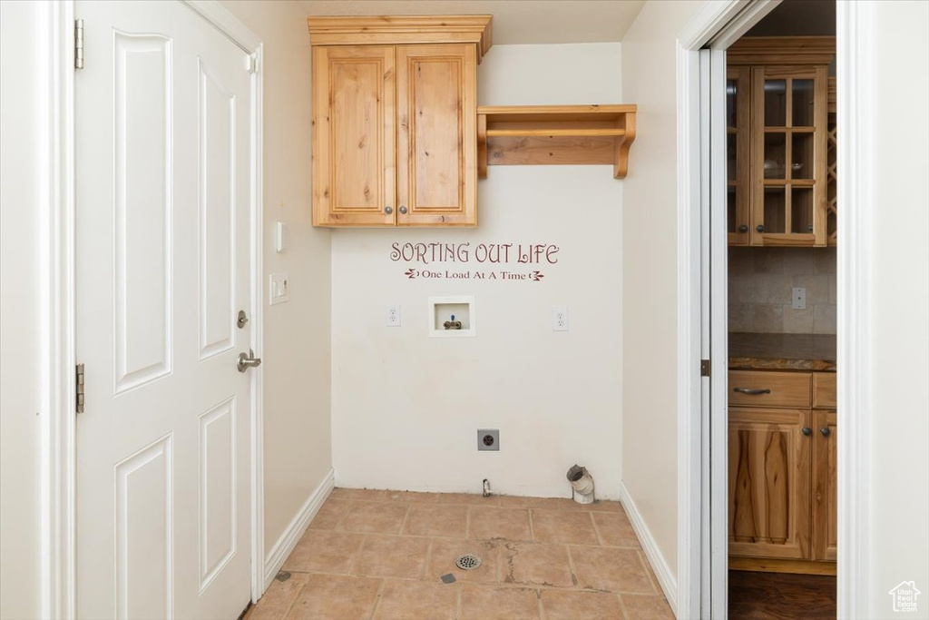 Laundry room featuring washer hookup, cabinets, hookup for an electric dryer, and light tile flooring