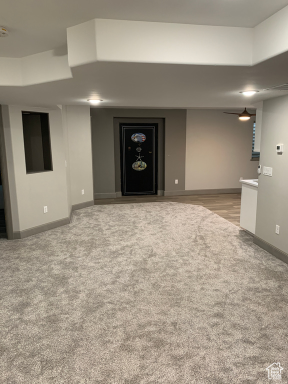 Interior space featuring light carpet and ceiling fan