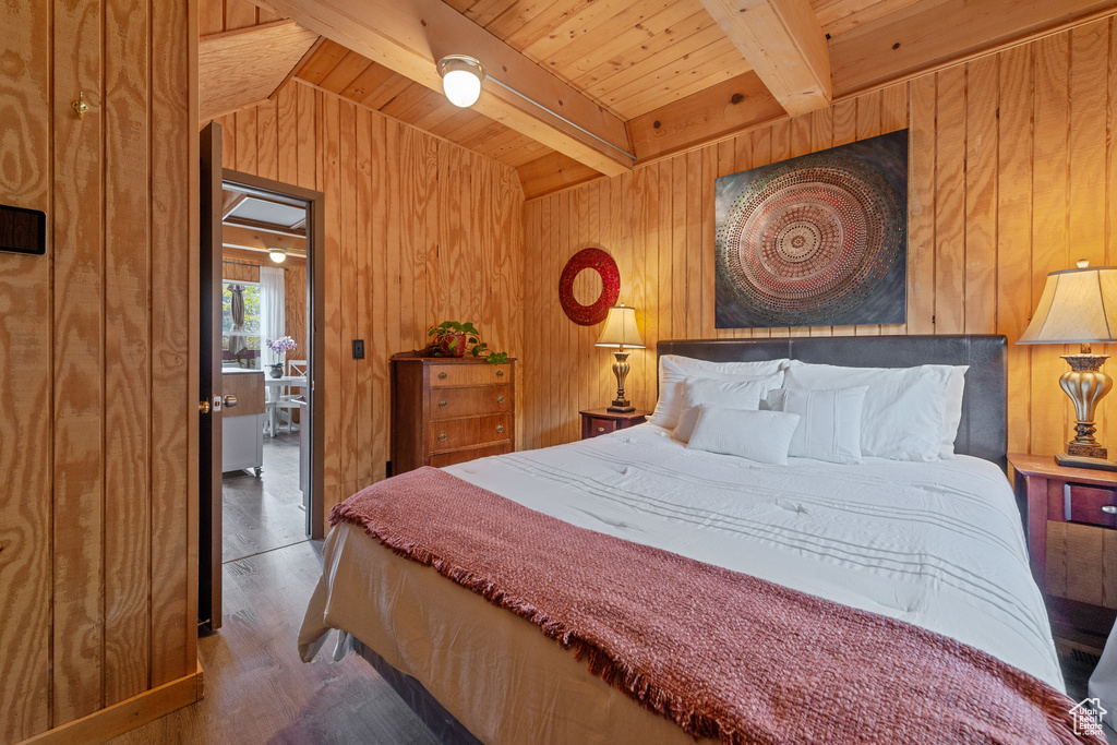 Bedroom with wood walls, hardwood / wood-style floors, wood ceiling, and beam ceiling