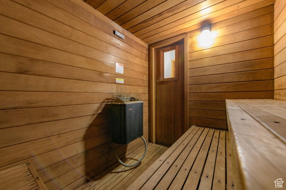 View of sauna / steam room featuring wood walls and wood-type flooring