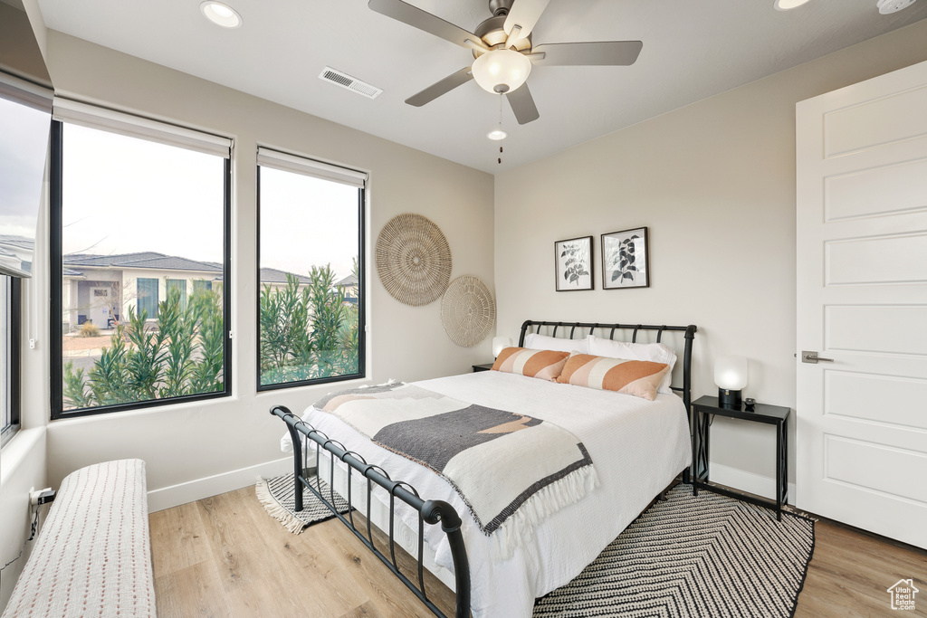 Bedroom with ceiling fan and light wood-type flooring