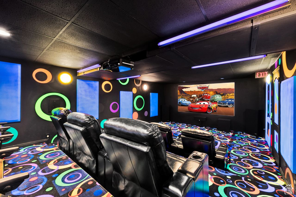 Home theater featuring carpet flooring and a drop ceiling