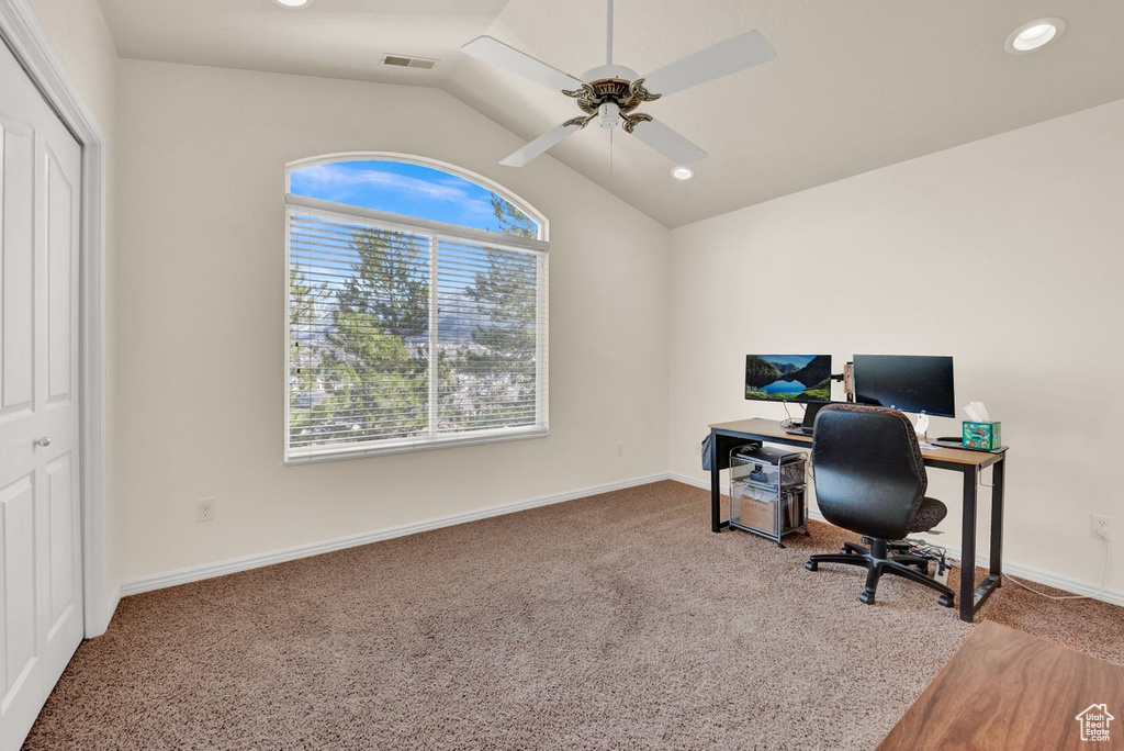 Carpeted office with ceiling fan and vaulted ceiling