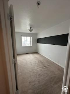 Unfurnished room featuring light colored carpet