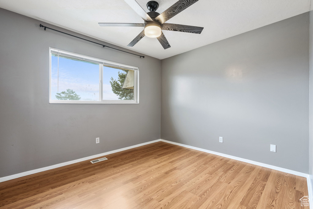 Spare room featuring ceiling fan and light hardwood / wood-style flooring