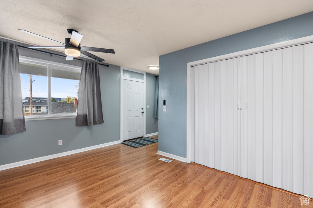Unfurnished bedroom featuring light hardwood / wood-style floors and ceiling fan