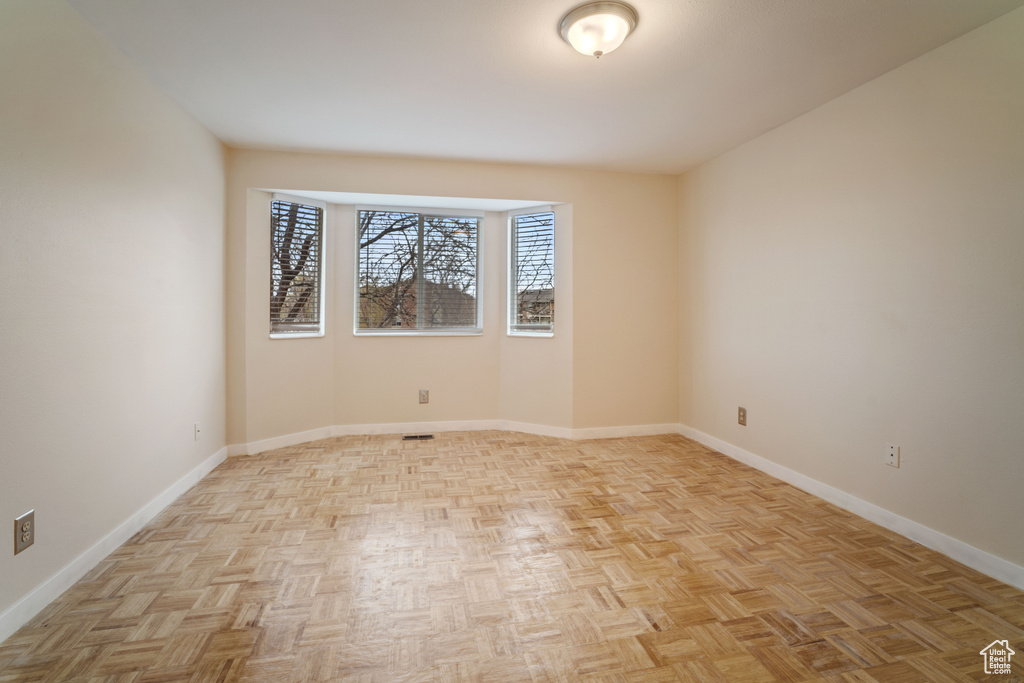 Empty room featuring light parquet flooring
