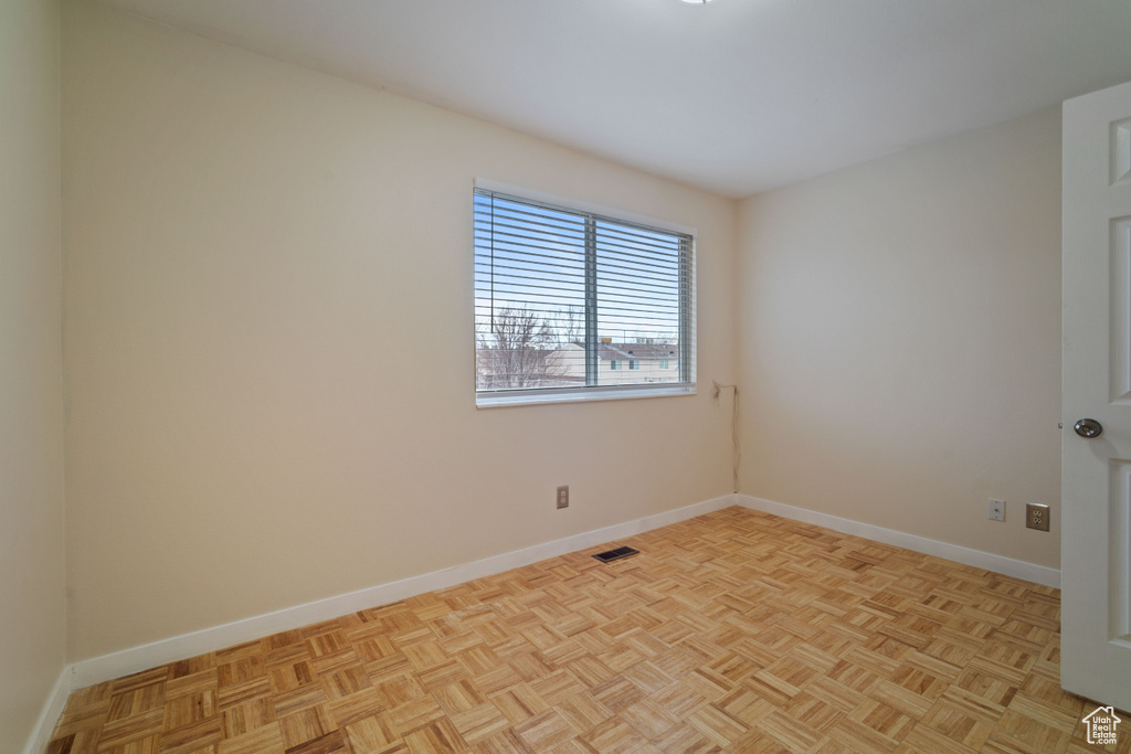 Spare room featuring light parquet floors