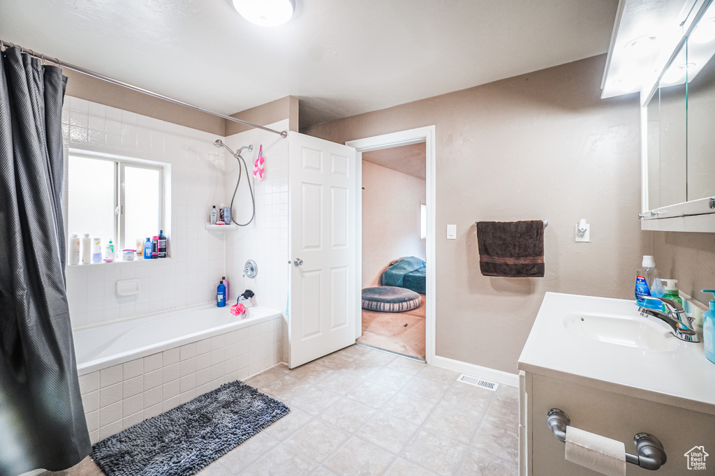 Bathroom featuring large vanity and tile floors
