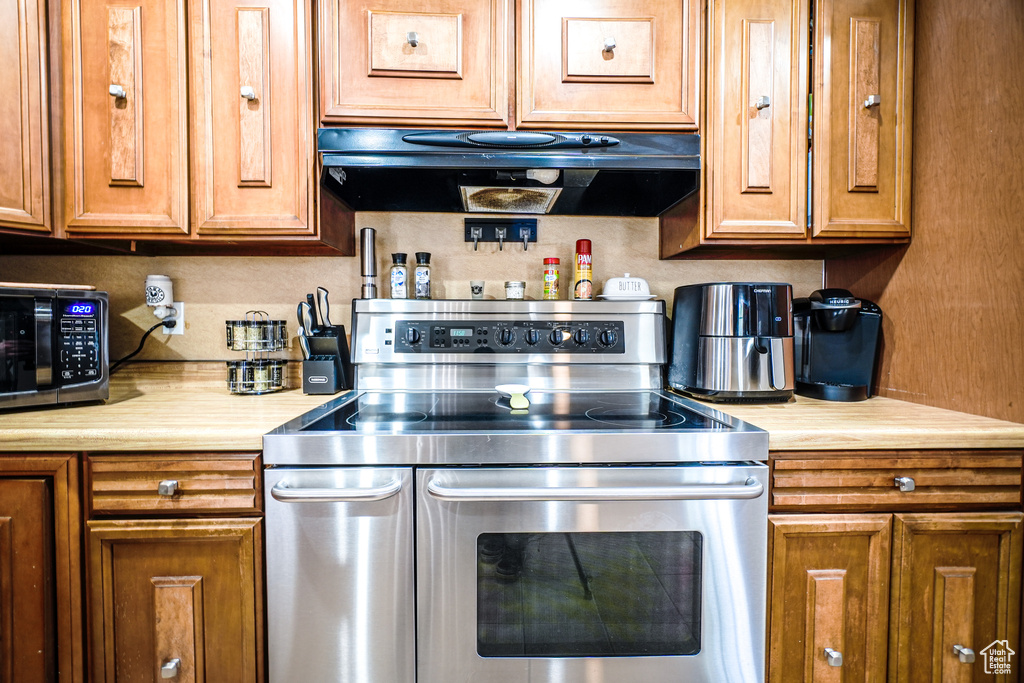 Kitchen with stainless steel appliances and exhaust hood