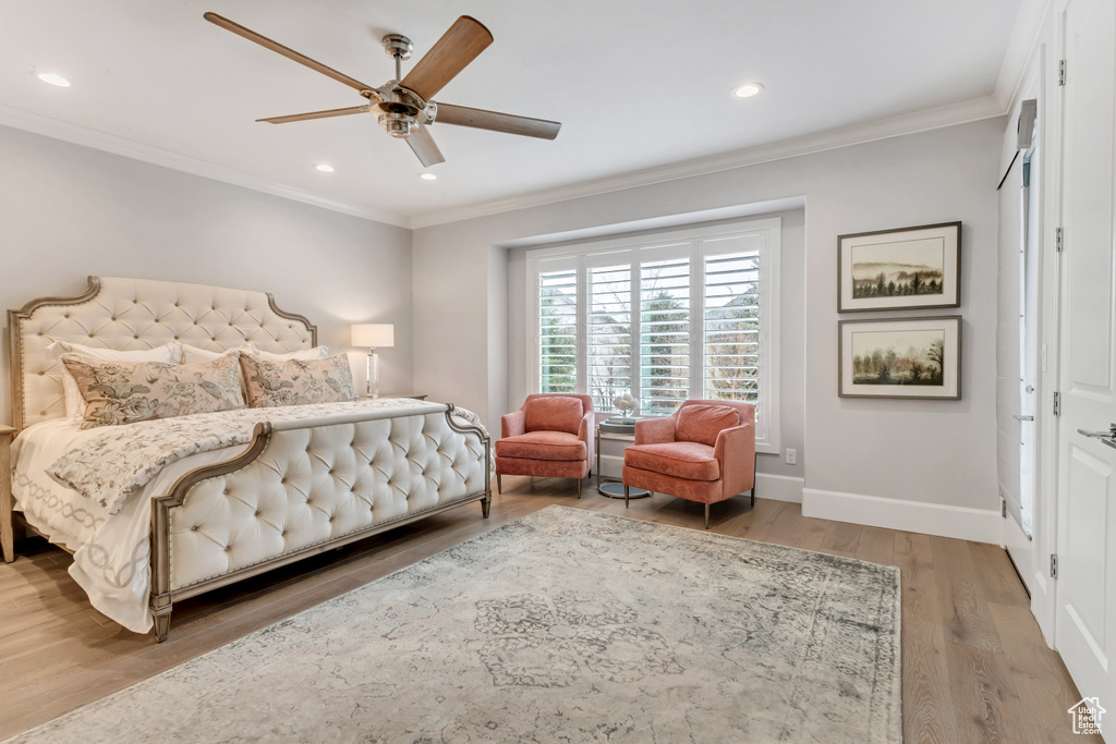 Bedroom featuring ornamental molding, wood-type flooring, and ceiling fan