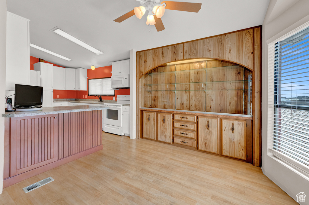 Kitchen featuring white appliances, ceiling fan, sink, white cabinets, and light hardwood / wood-style flooring