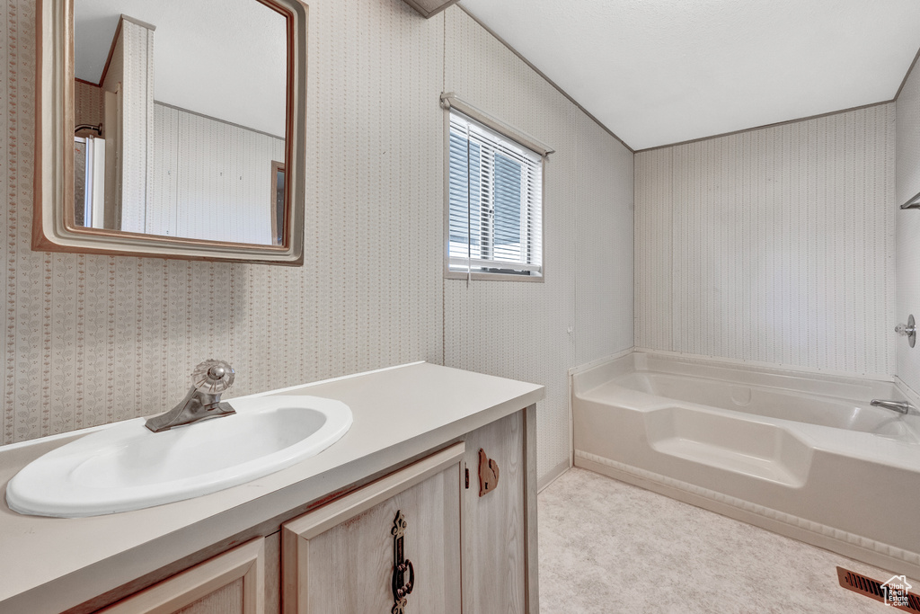 Bathroom with vanity and a washtub