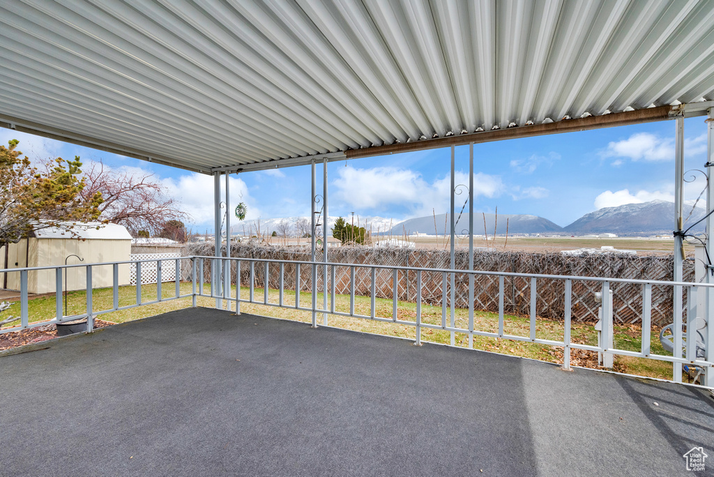 Unfurnished sunroom with a mountain view and a wealth of natural light