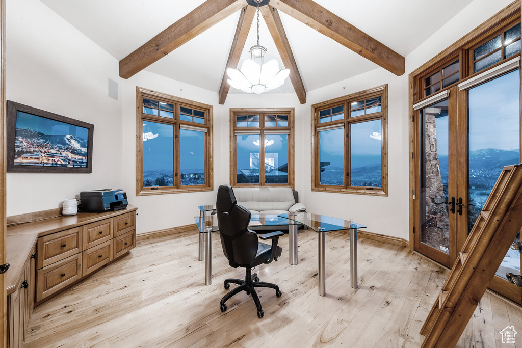 Office space with vaulted ceiling with beams, light hardwood / wood-style flooring, french doors, and an inviting chandelier