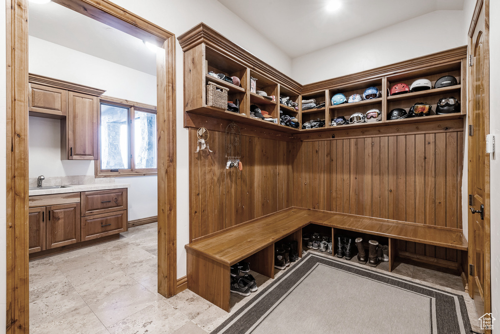 Mudroom featuring sink and light tile floors