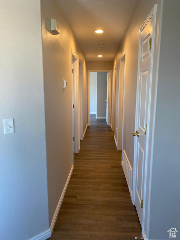 Hallway featuring dark wood-type flooring