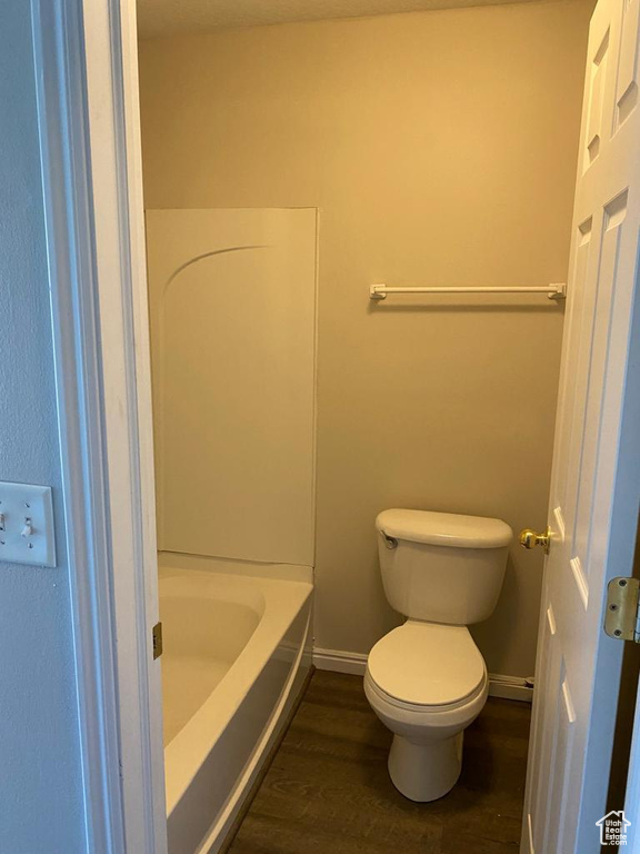 Bathroom with wood-type flooring and toilet