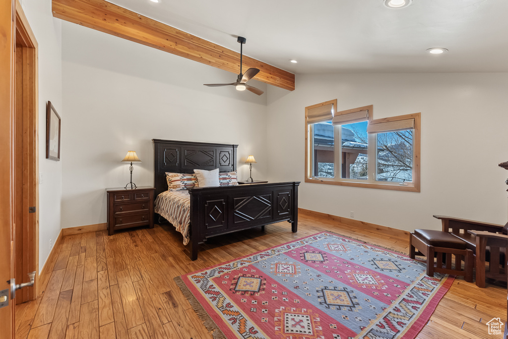 Bedroom with vaulted ceiling with beams, ceiling fan, and light wood-type flooring