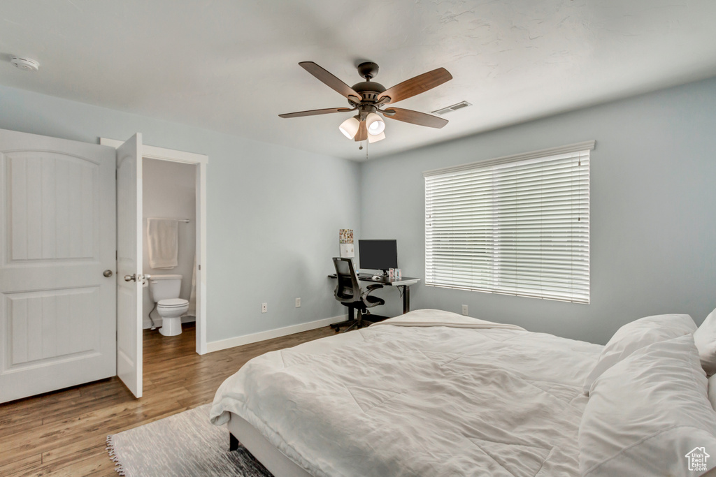 Bedroom featuring ensuite bathroom, ceiling fan, and light hardwood / wood-style flooring