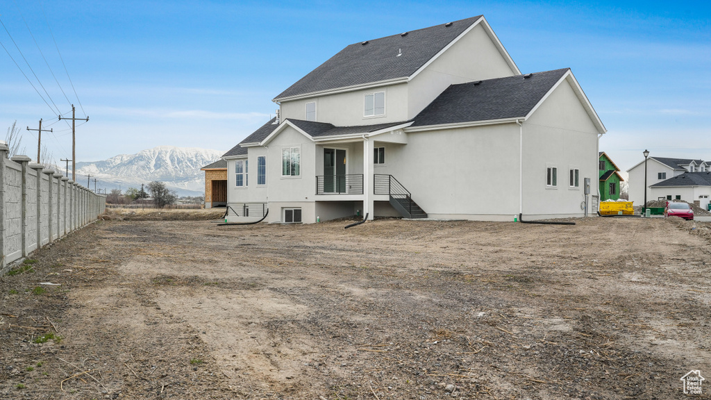 Rear view of property with a mountain view