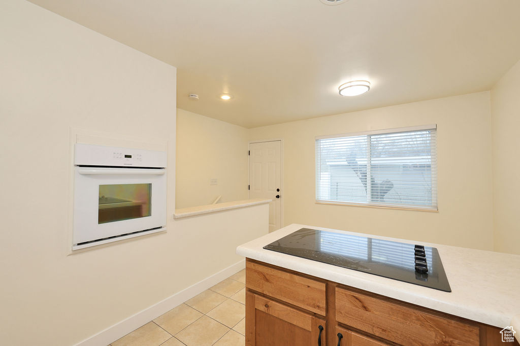 Kitchen with light tile flooring and oven