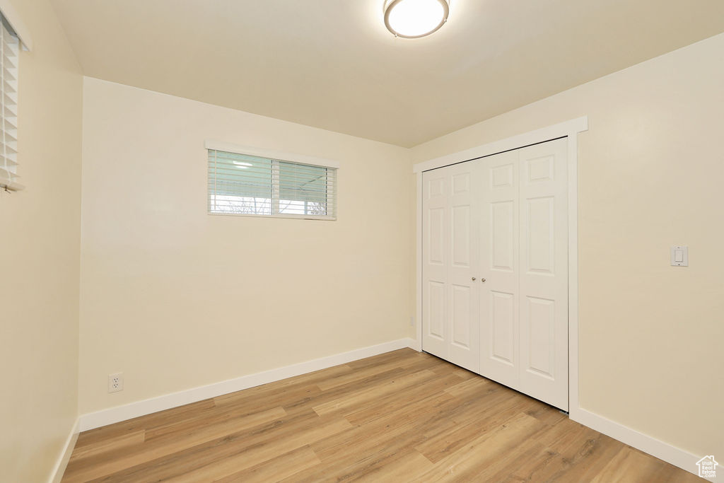 Unfurnished bedroom featuring a closet and light hardwood / wood-style flooring