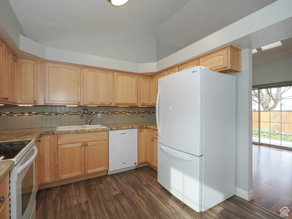 Kitchen featuring tasteful backsplash, white appliances, dark hardwood / wood-style floors, and sink