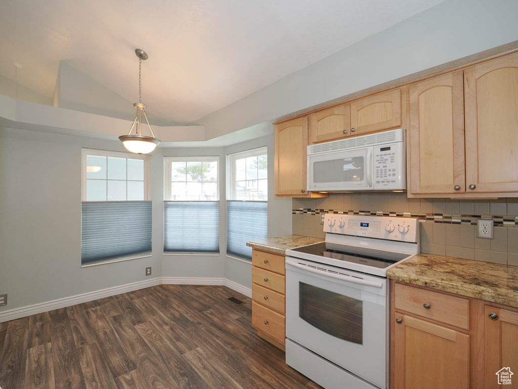 Kitchen featuring white appliances, dark hardwood / wood-style flooring, decorative light fixtures, tasteful backsplash, and light brown cabinets