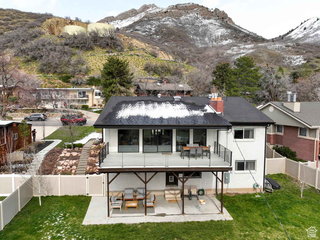 Rear view of house featuring a lawn, outdoor lounge area, a patio area, and a mountain view