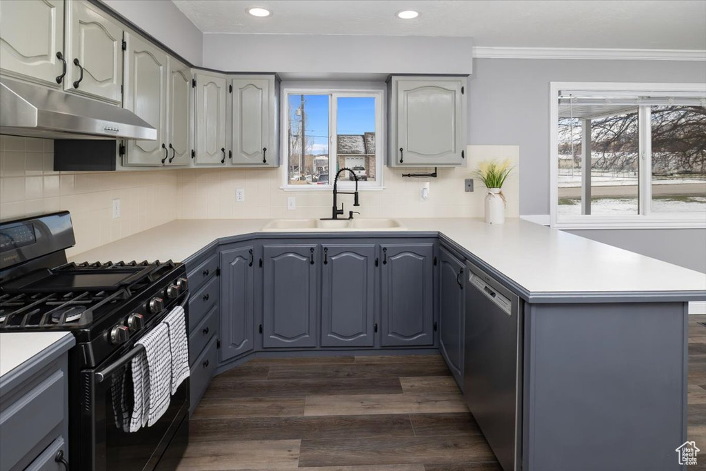 Kitchen with black gas range, gray cabinetry, dark hardwood / wood-style floors, and dishwasher