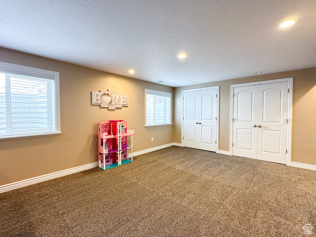 Playroom with dark colored carpet