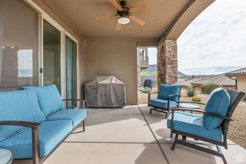 View of patio with outdoor lounge area, area for grilling, and ceiling fan