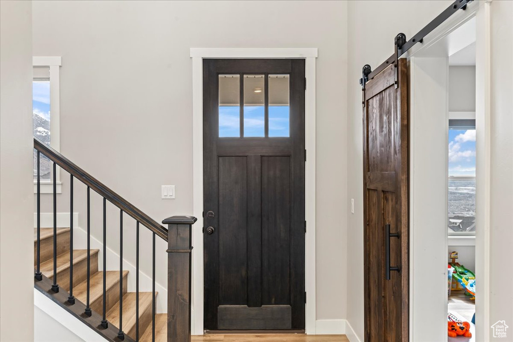 Entryway featuring a barn door, plenty of natural light, and light hardwood / wood-style floors