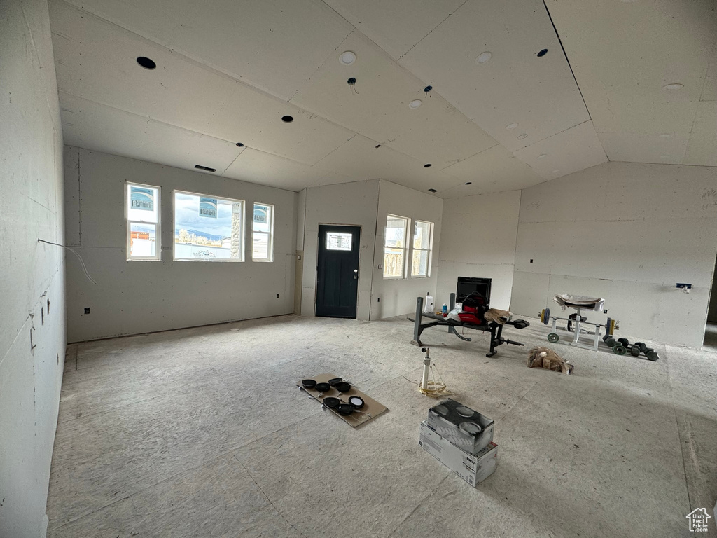 Exercise room with lofted ceiling and a wealth of natural light