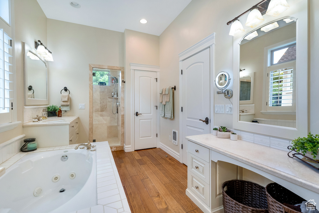 Bathroom with vanity, wood-type flooring, and separate shower and tub