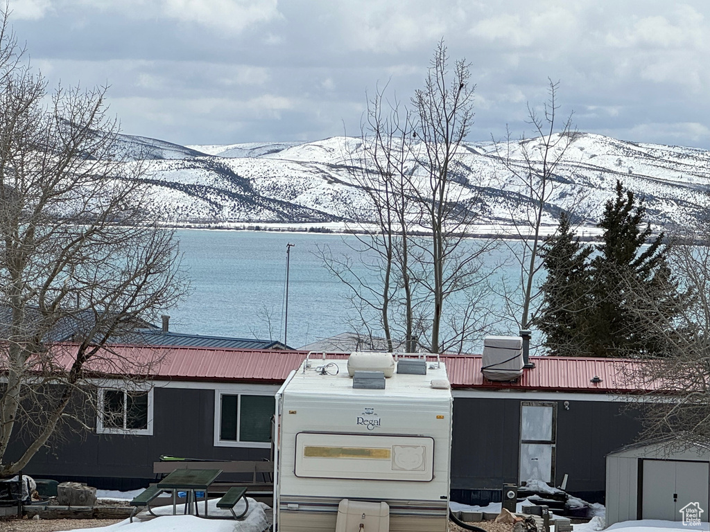 View of front of property featuring a mountain view and a storage unit