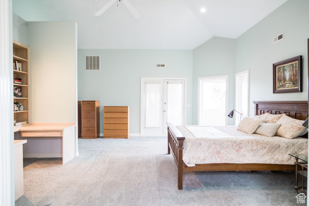 Bedroom with high vaulted ceiling, french doors, light colored carpet, and ceiling fan