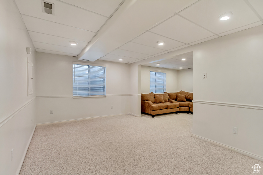 Sitting room with a paneled ceiling and light colored carpet