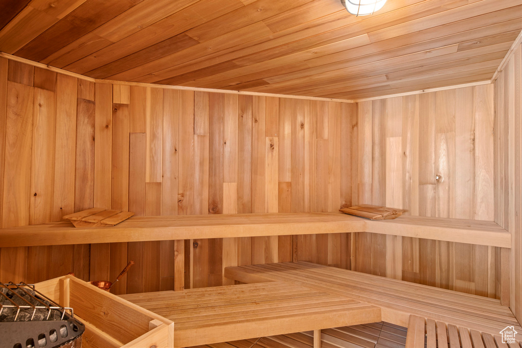 View of sauna with wood walls and wooden ceiling