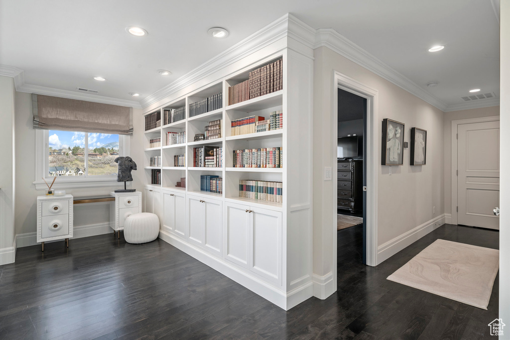 Interior space featuring dark hardwood / wood-style flooring and ornamental molding