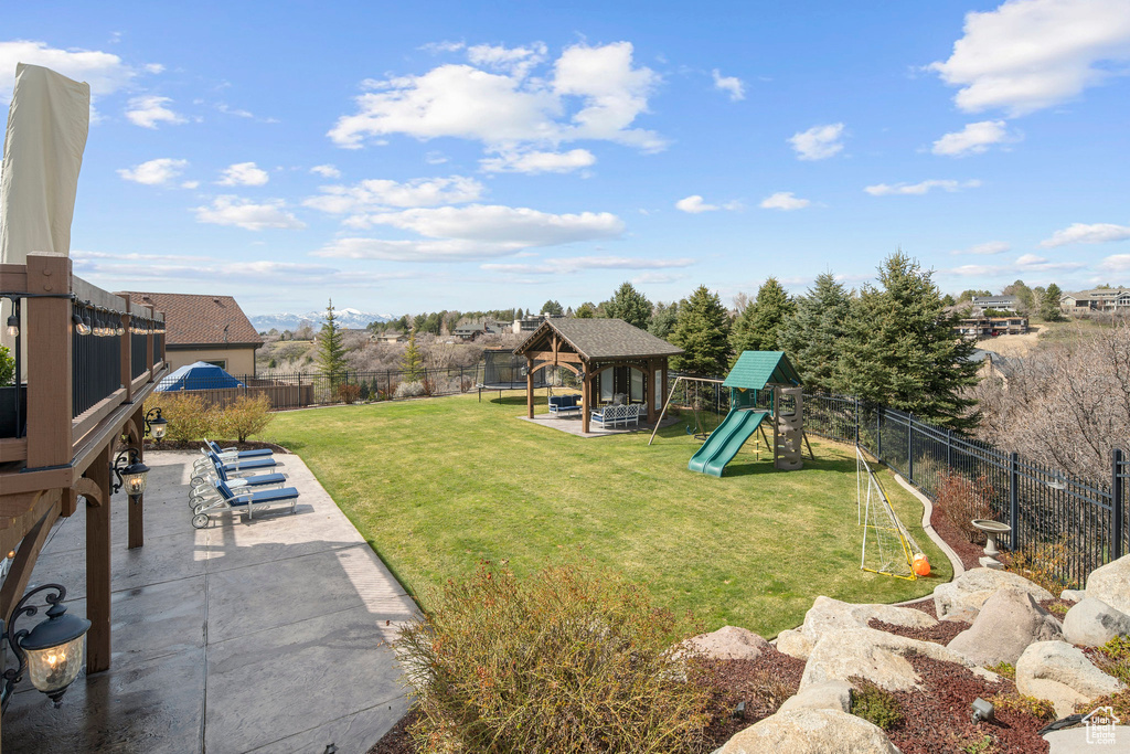 View of yard with a playground, a gazebo, and a patio area