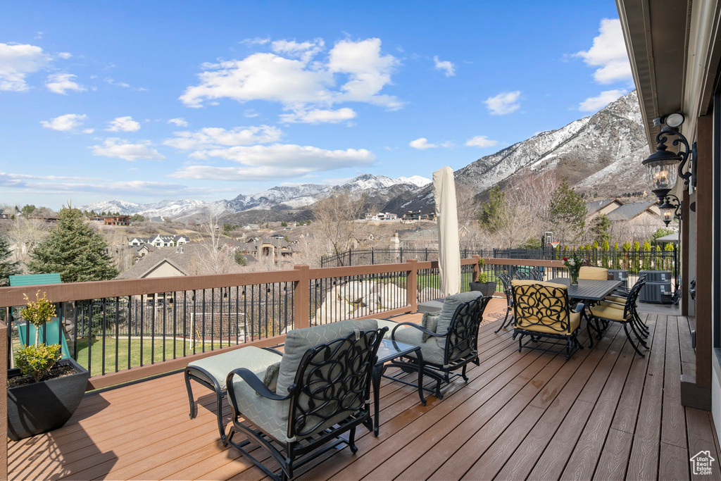 Deck with an outdoor living space and a mountain view