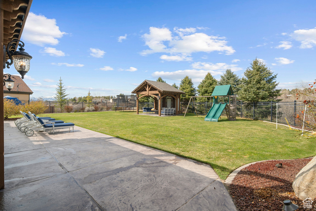 View of yard with a gazebo, a playground, and a patio