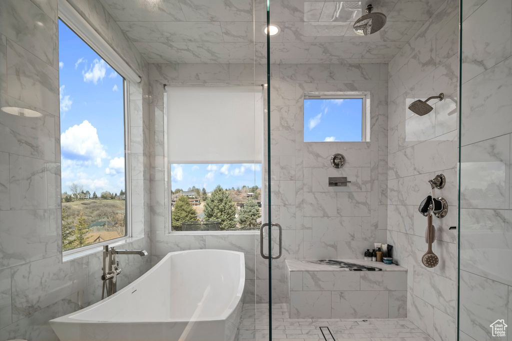 Bathroom with tile walls and separate shower and tub