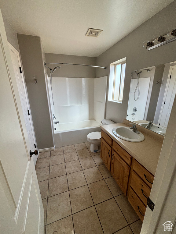 Full bathroom with tile floors, shower / washtub combination, toilet, and vanity