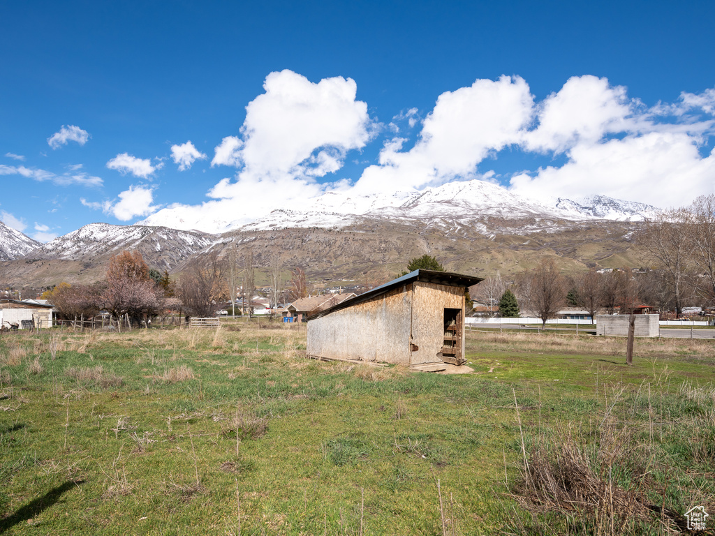 View of home's exterior featuring an outdoor structure, a mountain view, and a rural view
